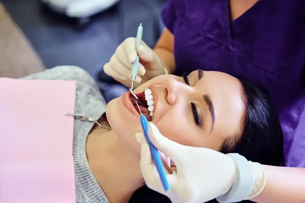 A woman having her teeth examined in a dental chair