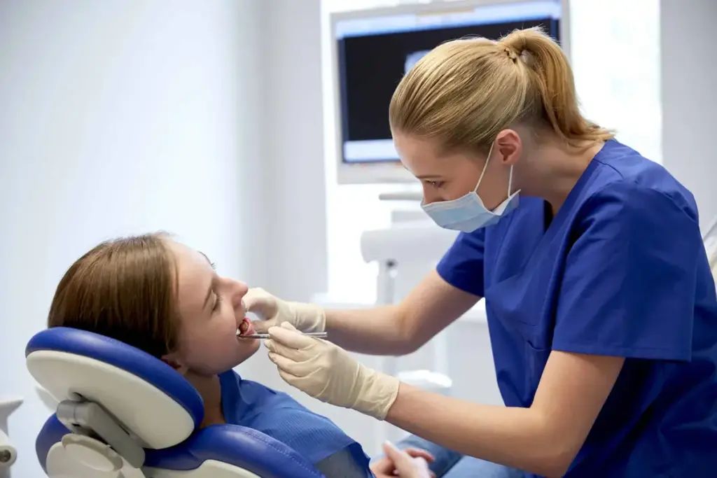 A young child having their teeth checked by a hygienist