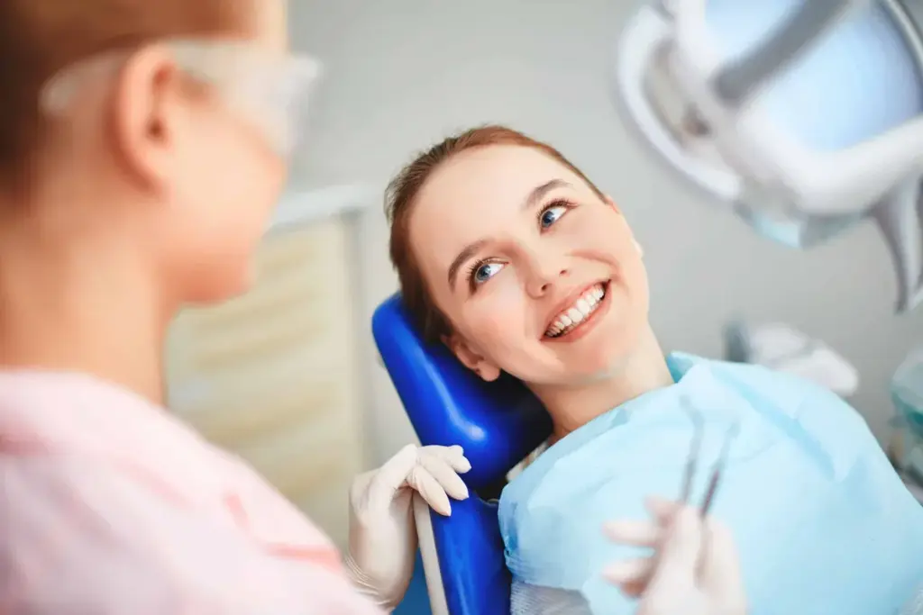 A young woman smiling in a dental chair